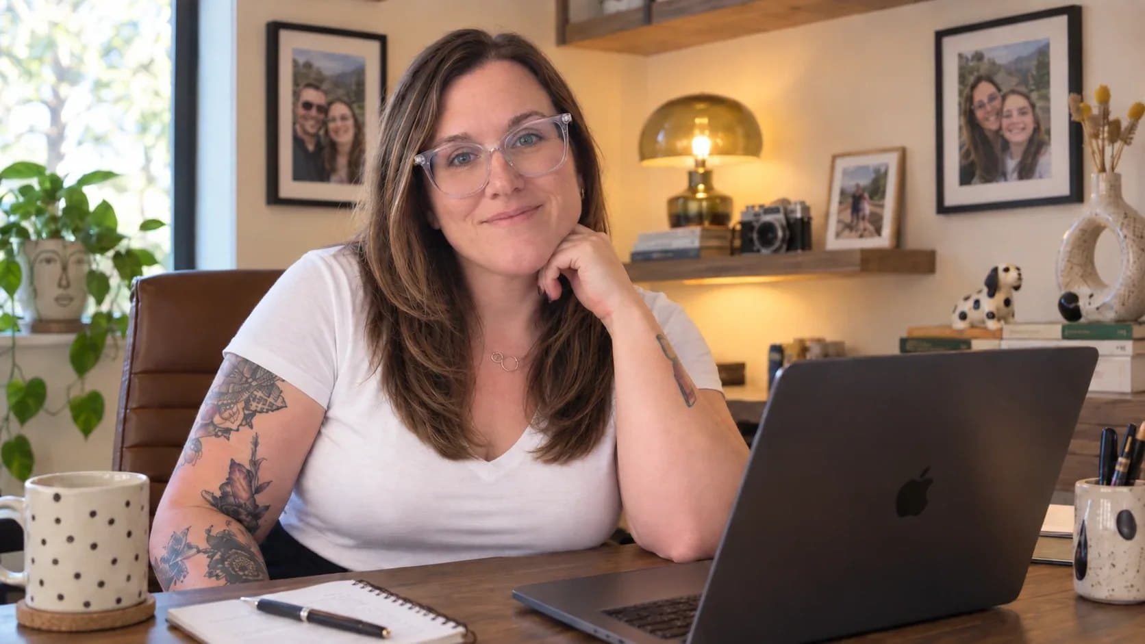 Tiffany Russell at her desk in her studio, coffee mug and laptop in front of her